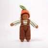 Toy figure of a child wearing a carrot hat on a white background